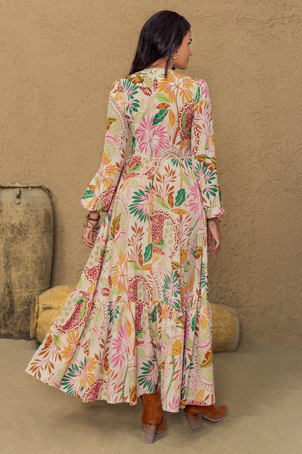 Long sleeve maxi dress with vibrant floral abstract print in green, orange, pink, and burgundy on a cream background, featuring buttons from mid-chest to mid-skirt and lace detailing around the neckline and under the bust.